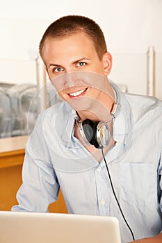 Young Man with Laptop and Headphones