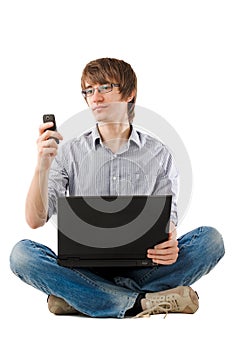 Young man with laptop and writing sms