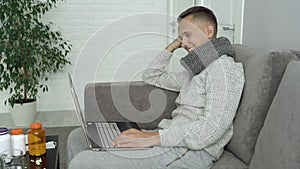 Young man laughing and watching movies while sick at home