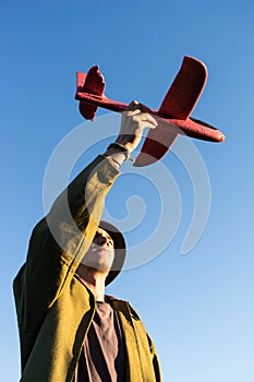 A young man launches a model of a toy plane