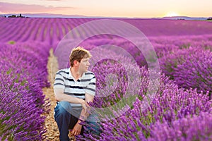 Young man in lavender fields, in Provence, France