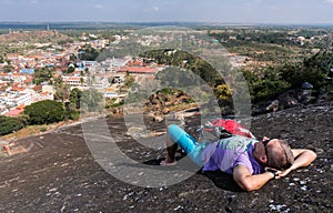 Young man is laying on a mountain and having rest