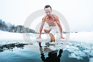 Young man with lean muscular body going to swim