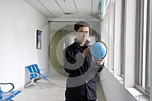 Young man learning globe