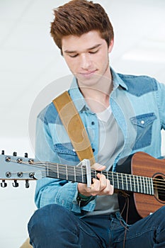 young man learning guitar