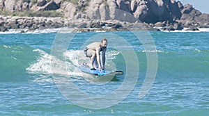 Young Man Learning to Surf on the Ocean in Mexico