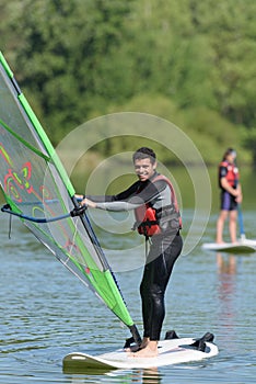 young man learning to windsurf