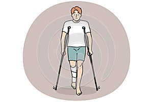 Young man with leg injury walk on crutches