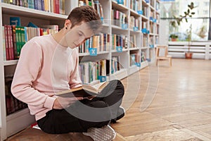 Young man at the library or bookstore