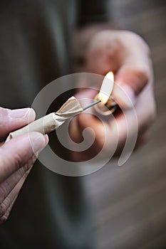 Young man lighting a firecracker