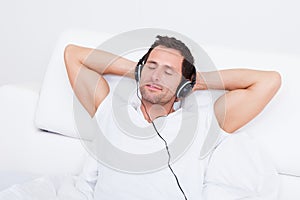 Young Man Listening Music On Headphone