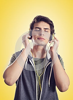 Young man listening music with headphones