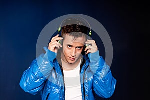 Young man listening music with headphones portrait