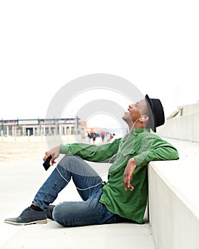 Young man listening to music on mobile phone