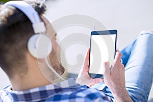 Young man listening to music on a smart phone
