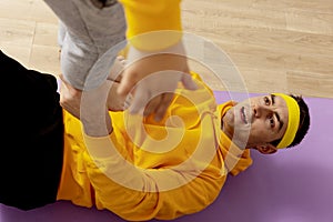 Young man with little boy doing fitness exercises at home. Father and son having fun during sport. Dad and his child