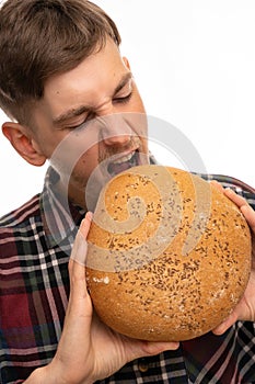 Young man with loaf of bread on white