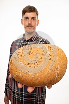 Young man with loaf of bread on white