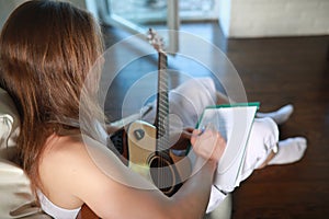 Young man with long hair with a guitar