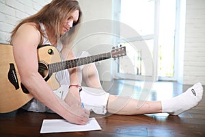 Young man with long hair with a guitar