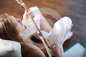 Young man with long hair with a guitar