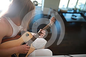 Young man with long hair with a guitar