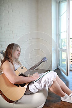 Young man with long hair with a guitar