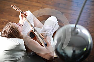 Young man with long hair with a guitar