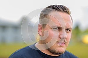 Young man looking at the camera in puzzlement