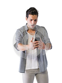 Young man looking at cell phone with angry expression