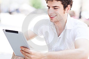 Young man looking at digital tablet