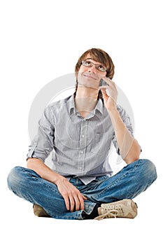 Young man looking dreamy with mobile phone