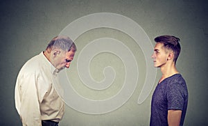 Young man looking at elder depressed himself