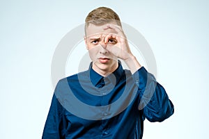 Young man looking far away isolated on white