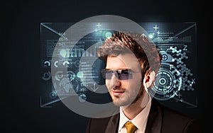 Young man looking with futuristic smart high tech glasses