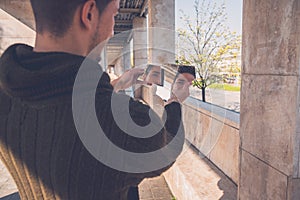 Young man looking at himself in a broken mirror