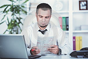 A young man is looking for a job. The guy looks at the job ads. Job wanted.