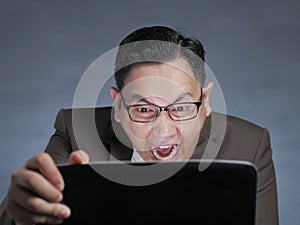 Young Man Looking at Laptop, Angry Gesture