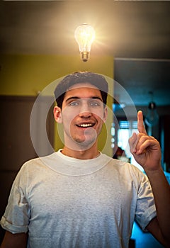 Young man looking at lit up lightbulb. Idea, enlightment concept