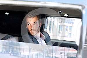 Young man looking out of limousine window