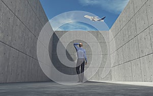 Young man looking over wall