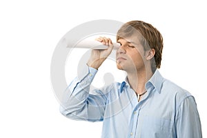 Young man looking through paper