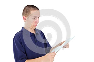 Young man looking at paper with disbelief