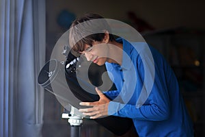 Young man looking at stars through telescope