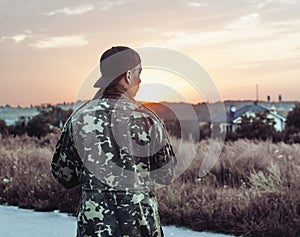 Young man looking at the sunset