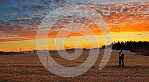 Young man looking to famous witer sunrise on Czech countryside