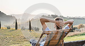 Young man looking at the valley in Italy, relaxation, vacations, lifestyle concept