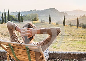 Young man looking at the valley in Italy, relaxation, vacations, lifestyle concept