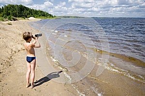 Young man looks in the binocular