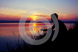 A young man looks at the sunset